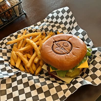 Main Street burger with fries on checkered paper